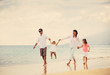 © EpicStockMedia - Happy Family have Fun Walking on Beach at Sunset