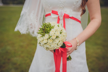 wedding bouquet in hands of the brid