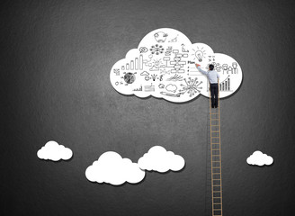 Businessman climbing ladder drawing idea on cloud