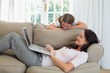 © lightwavemedia - Mother using laptop while daughter looking at it