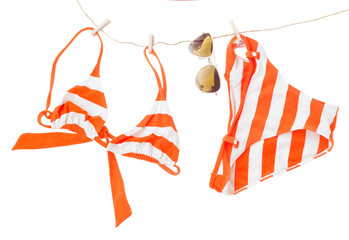 swimming suit with glasses hanging on rope