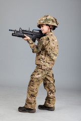 Wall Mural - Young boy dressed like a soldier with rifle