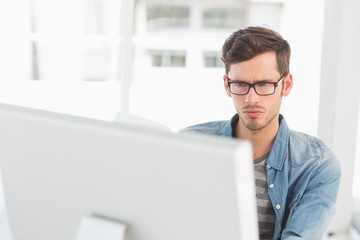 Wall Mural - Concentrated young male artist using computer