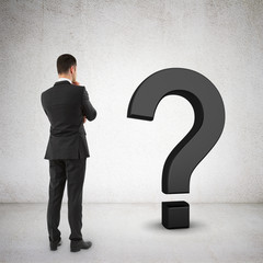 Wall Mural - businessman looking at question mark