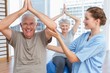 © WavebreakMediaMicro - Therapist assisting senior couple with exercises