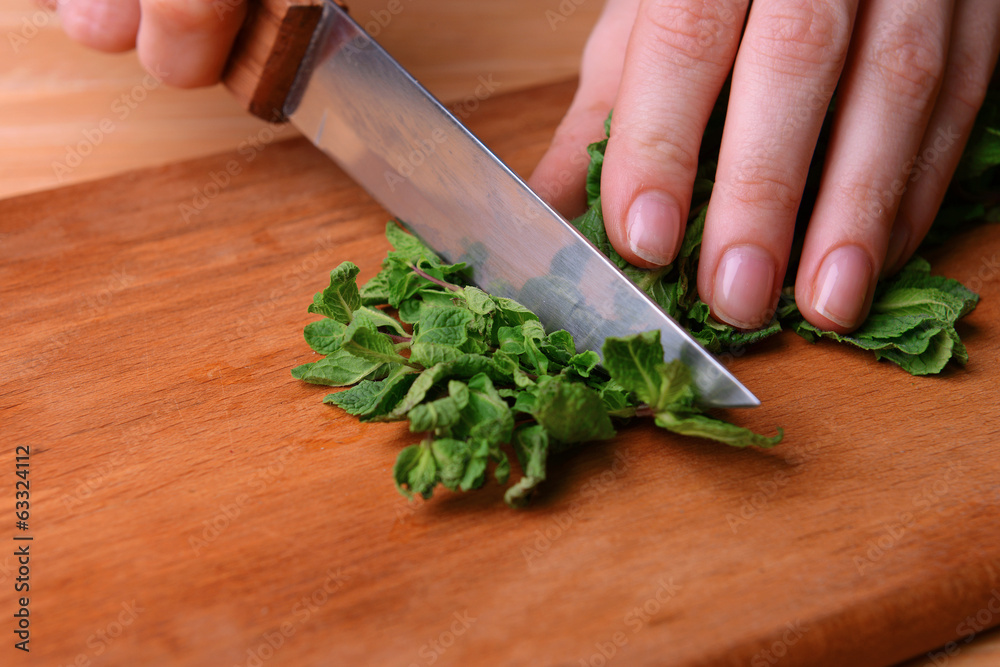 Chopped mint on wooden board close-up