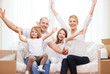 © Syda Productions - smiling parents and two little girls at new home