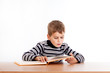 © Sergii Figurnyi - Cute schoolboy is reading a book