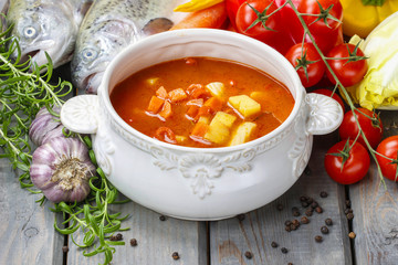 Wall Mural - Bowl of tomato soup on wooden table