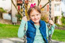 Spring Portrait Of A Cute Little Girl Playing On Playground