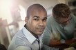 © goodluz - Portrait of young man in business meeting