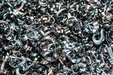 Closeup twisted spiral steel shavings. Drilling industry