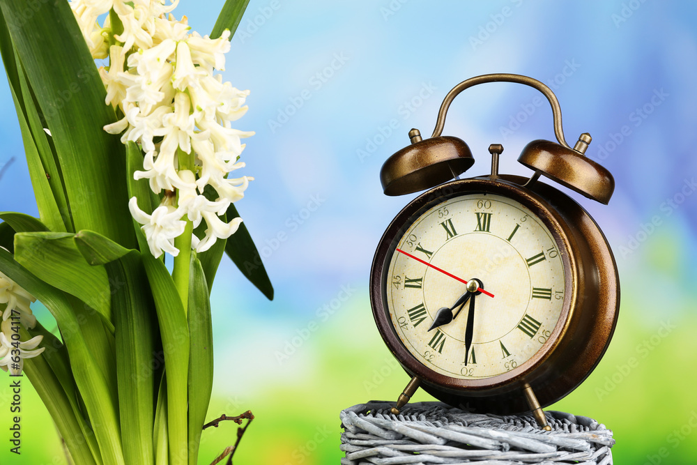 Alarm clock on nature background