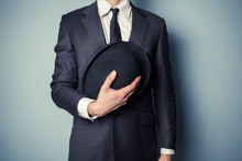 Man Holding A Bowler Hat