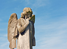 Winged Angel Statue In Graveyard