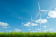wind turbine with grass and blue sky