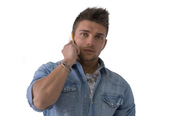 Wall Mural - Handsome young man talking on cell phone (mobile), isolated