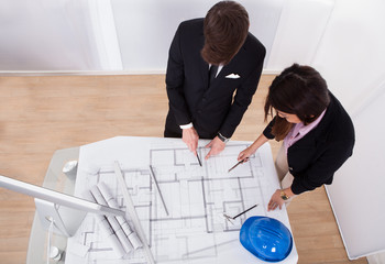 Poster - Architects Discussing Over Blueprint