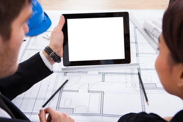 Poster - Architects With Digital Tablet Working On Blueprint