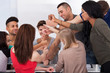 © Andrey Popov - University Students Piling Fists
