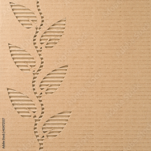 Fotografía Leaves cut out on a corrugated cardboard