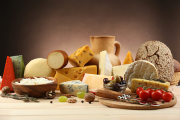 Wall Mural - Tasty dairy products on wooden table, on dark background