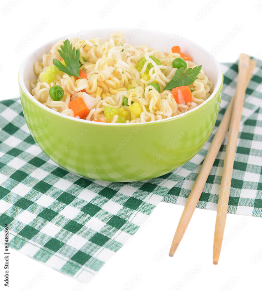 Tasty instant noodles with vegetables in bowl on table close-up