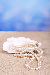 Wall Mural - Beautiful pearls in shell on sand, close up