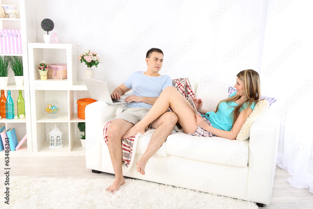 Loving couple  relaxing with laptop  and tablet,