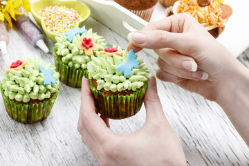 Sticker - Woman decorates easter cupcakes