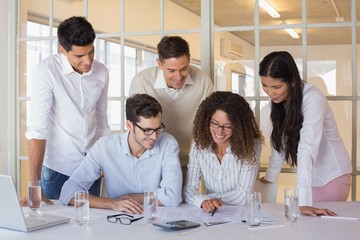 Casual business team working together at desk