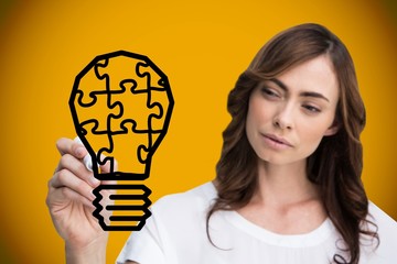 Wall Mural - Composite image of businesswoman drawing light bulb