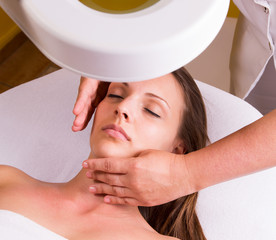 Woman is having cosmetic treatment at beauty salon.