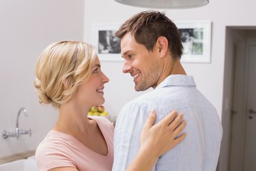 Wall Mural - Loving couple looking at each other at home