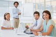 © lightwavemedia - Businessman giving presentation to colleagues in office