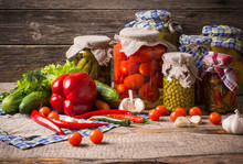 Preserved  And Fresh Vegetables On Wooden Background