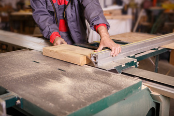 Hands carpenter working with a circular saw