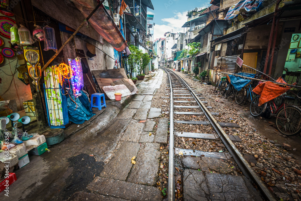 Railway crossing the street in city, Vietnam. - obrazy, fototapety, plakaty 