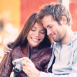 © Maridav - Couple looking at pictures on camera