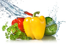 Red, Yellow, Green Pepper And Parsley With Water Splash Isolated