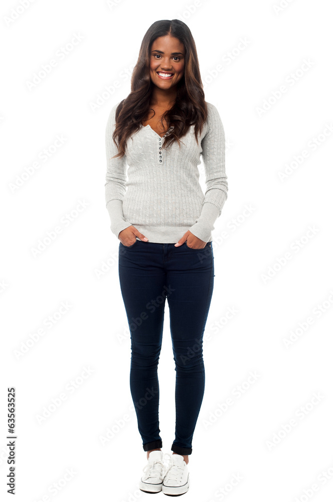 Smiling young woman posing with hands in pockets Stock Photo | Adobe Stock