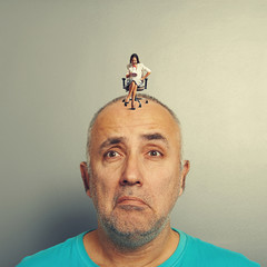 Canvas Print - sad man and small angry businesswoman