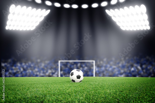 Fototapeta na wymiar Soccer ball on field in stadium at night