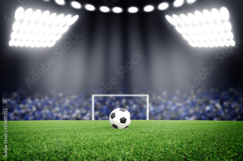 Fototapeta do kuchni Soccer ball on field in stadium at night