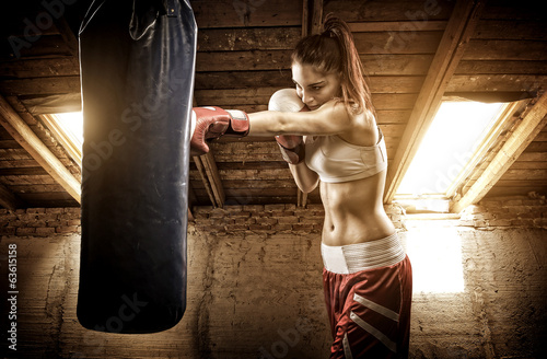 Obraz w ramie Young woman boxing workout on the attic