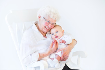 Beautiful grandmother singing to her newborn baby grandson