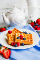 Sticker - Belgian waffles with berries on rustic background