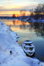 Winter Sunset On The River With A Boat