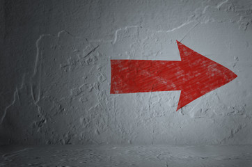 Red arrow on white wall