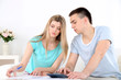 © Africa Studio - Young couple calculating finance at desk,